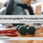 Desk exercise gadgets including resistance bands, dumbbells, and an exercise ball on a wooden floor